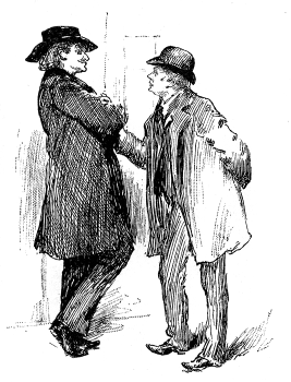 Two men stand talking.