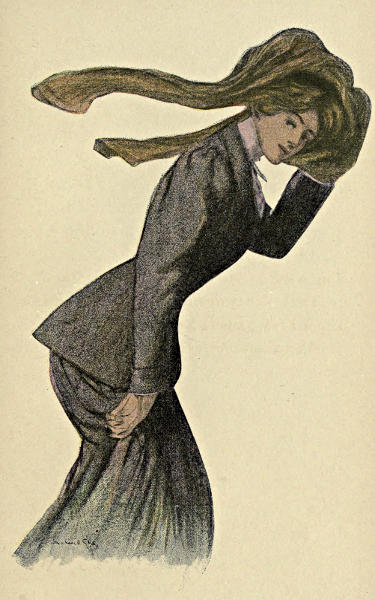Lady holding her hat on to avoid it being blown away