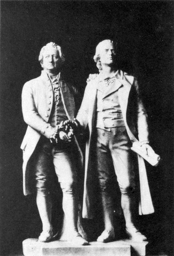 Statue of Goethe and
  Schiller, taking hold of a laurel wreath